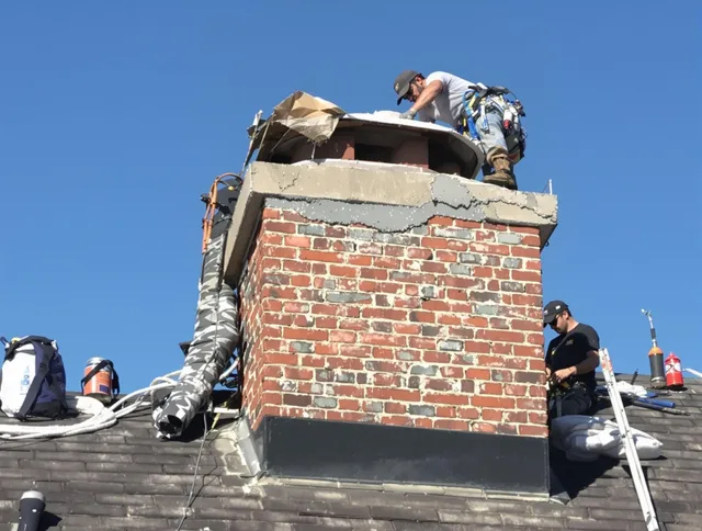Stoneham Chimney Sweep installing a custom chimney crown in Stoneham, MA