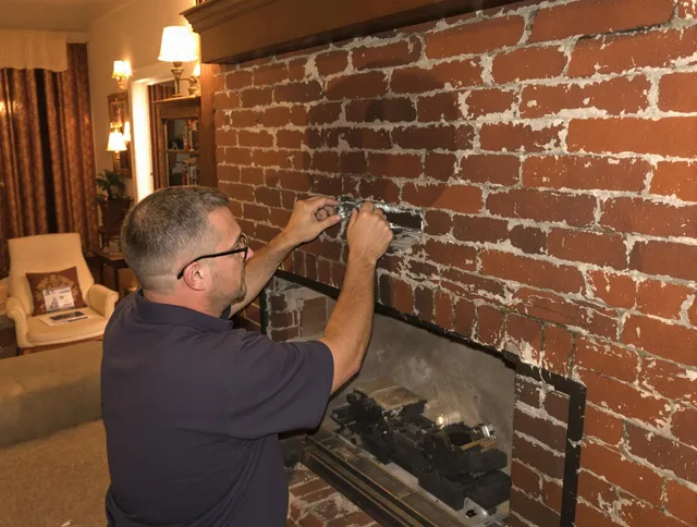 Stoneham Chimney Sweep expert fixing a fireplace in Stoneham, MA